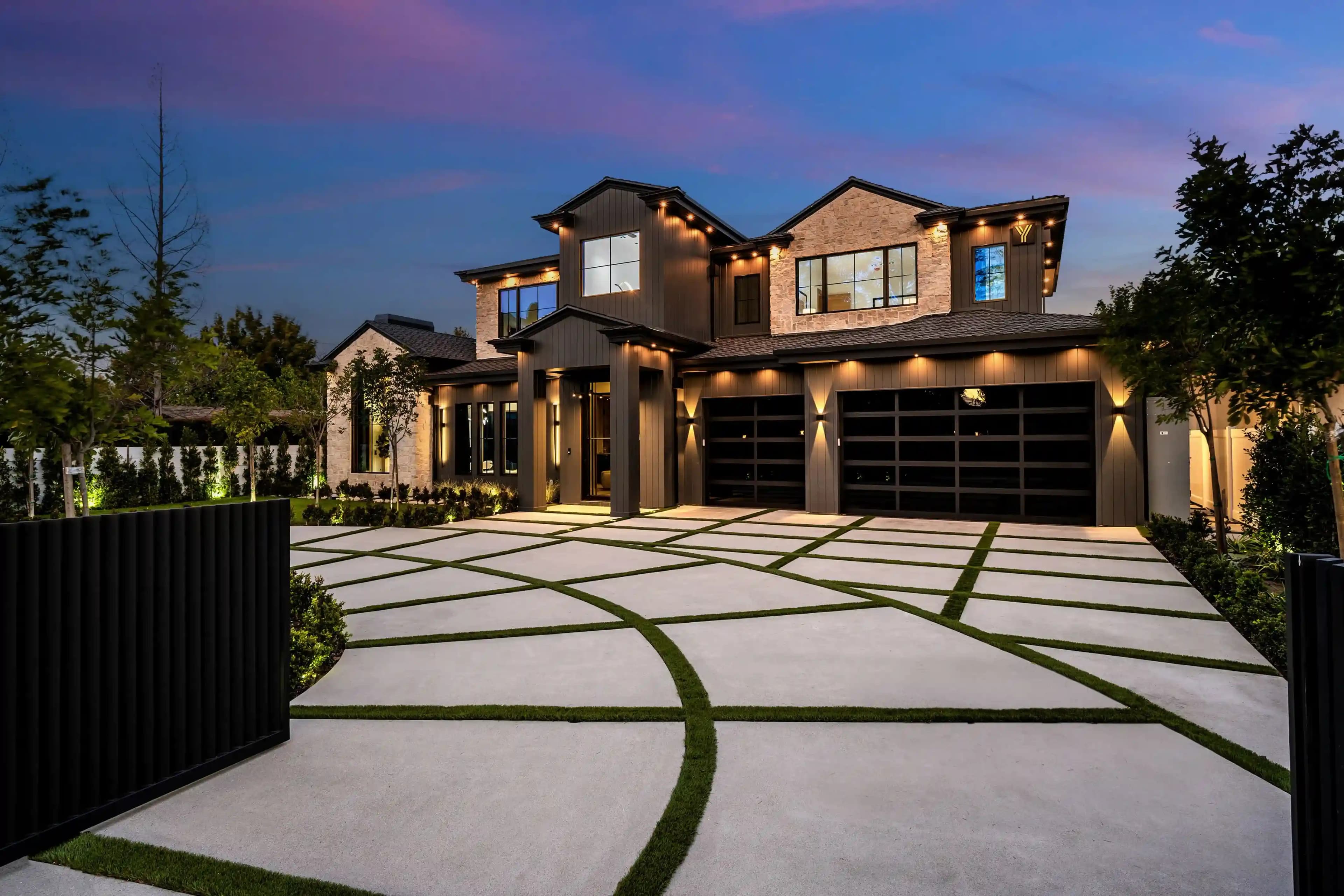 Modern luxury family home glowing at dusk